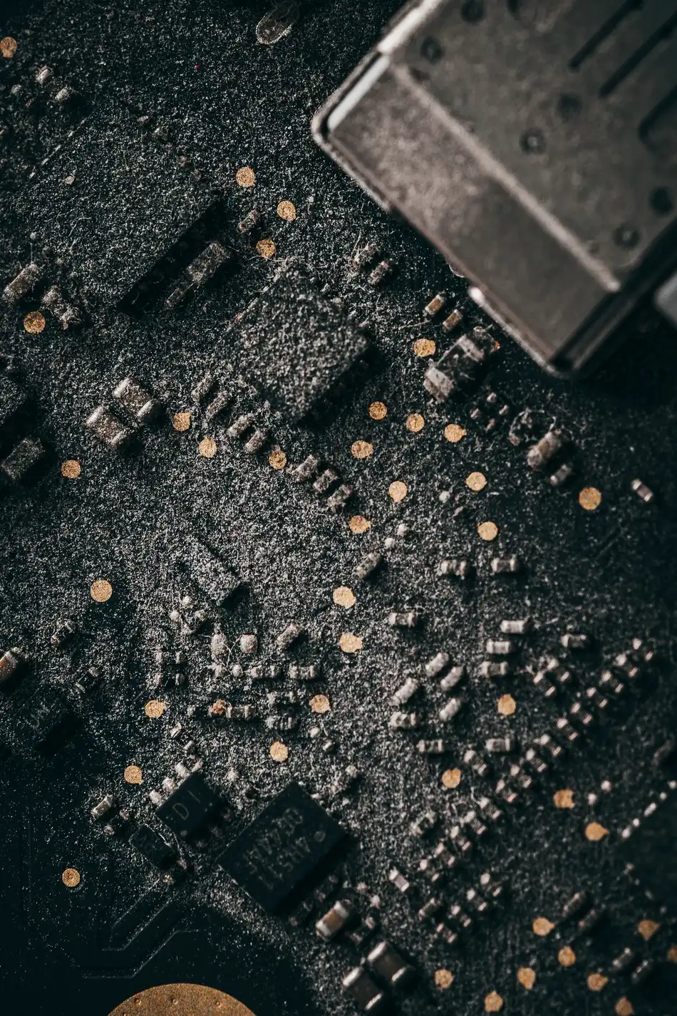 Macro photograph of a dark blue circuit board showing its traces.