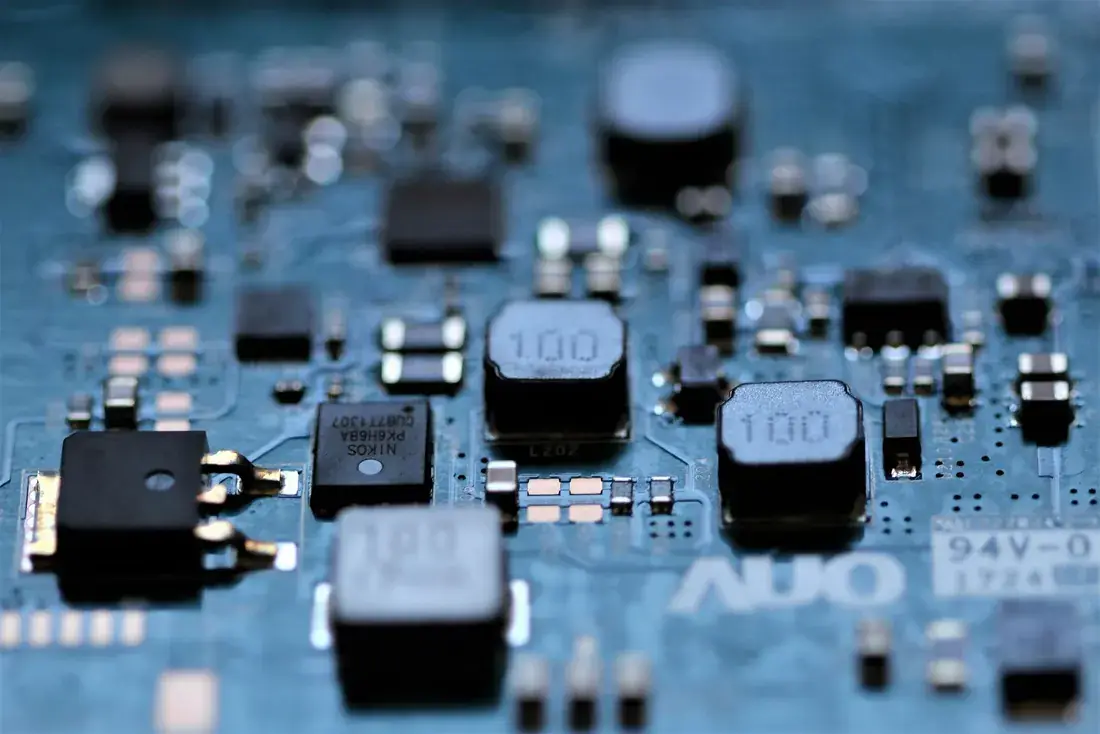 Macro photograph of a green motherboard with shallow depth of field.